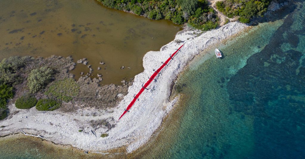 red wound and black stitches turn bulldozer scar into land art by the krank